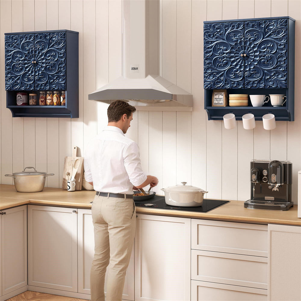 Man cooking in a modern kitchen with decorative blue wall cabinets.