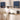 Man cooking in a modern kitchen with decorative blue wall cabinets.