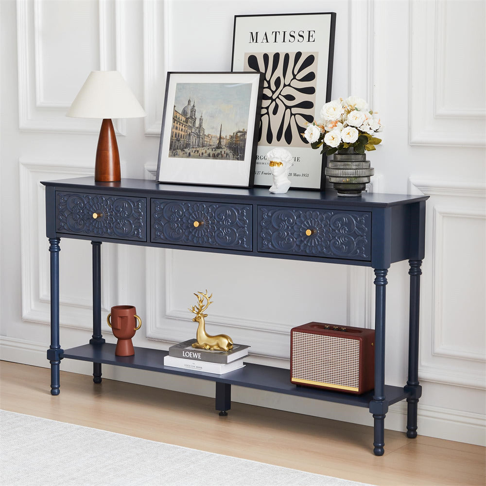 Navy blue console table with decorative items in a room with white walls and a lamp.