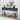 Navy blue console table with decorative items in a room with white walls and a lamp.
