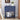 Navy blue nightstand with decorative drawer and shelf, featuring books and a small statue.