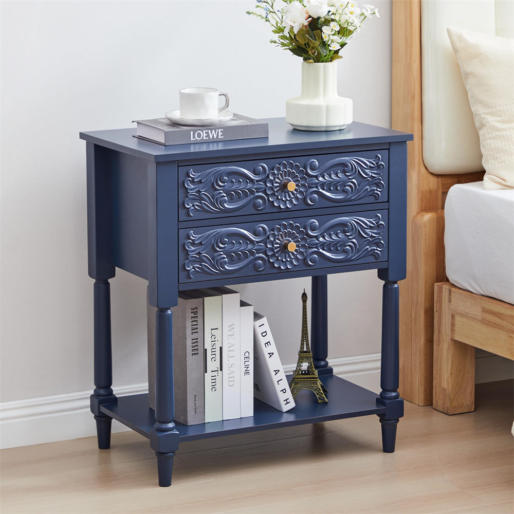 Navy blue nightstand with floral patterns, books, and a vase in a bedroom setting.