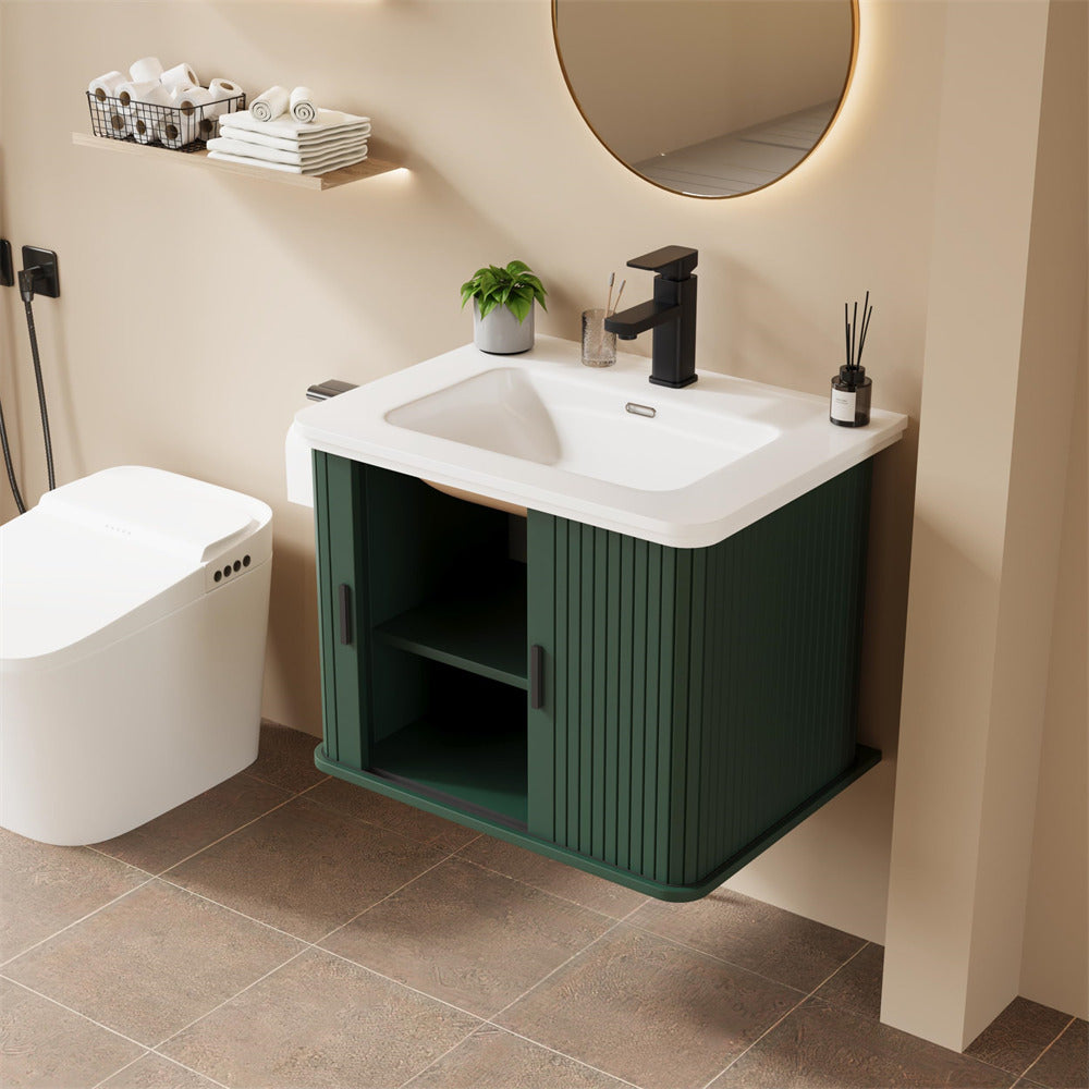 Bathroom with a green vanity unit, white sink, and toilet.