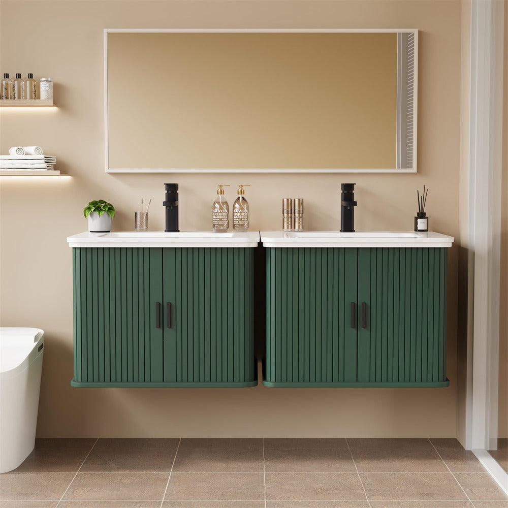 Bathroom vanity with green cabinets, white countertop, and decorative items on a beige wall.