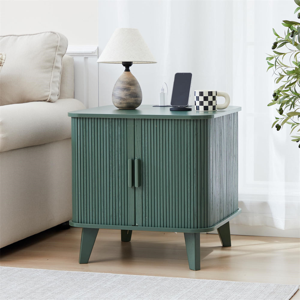 Green side table with lamp, phone, and mug in a living room setting
