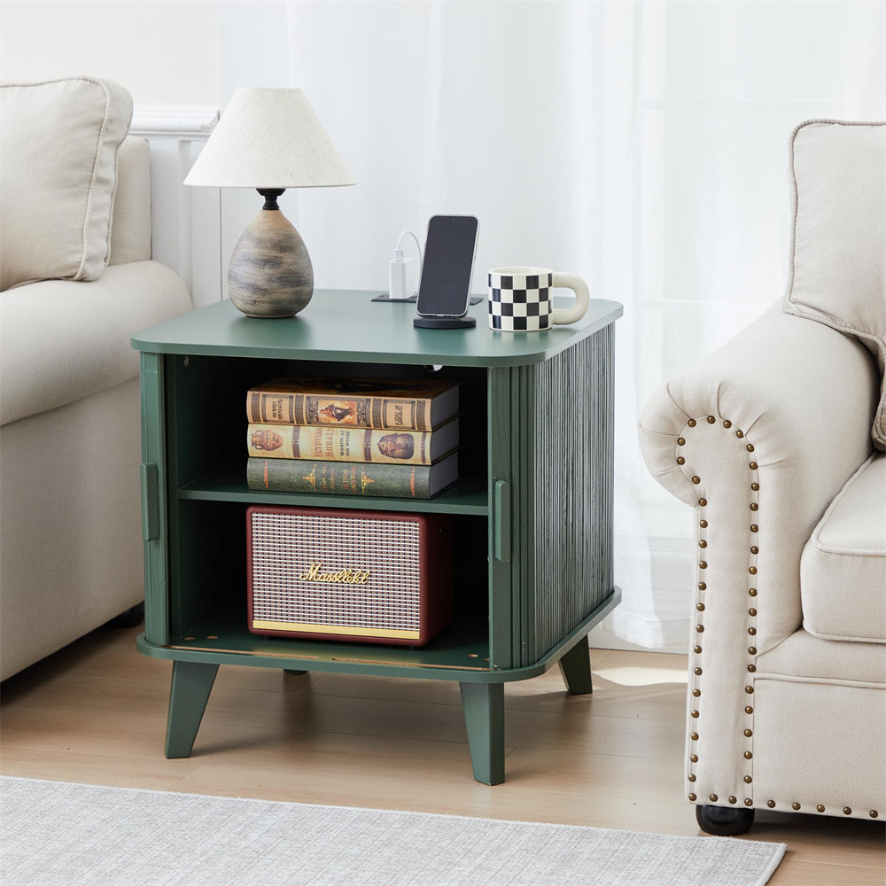 Green side table with books and a radio in a living room setting