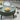 Round coffee table with a laptop, cup, and bread on top, surrounded by lifestyle elements.