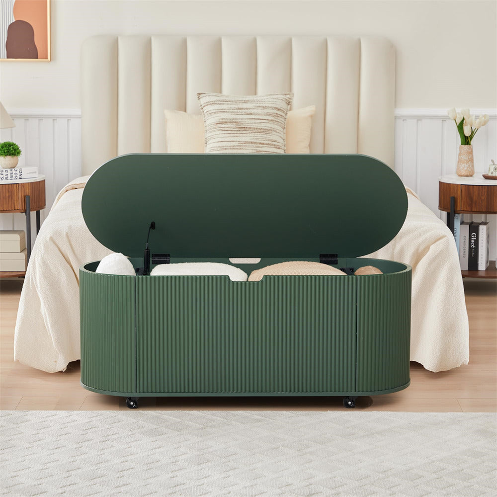 Green storage bench in a bedroom setting with a bed and nightstands.
