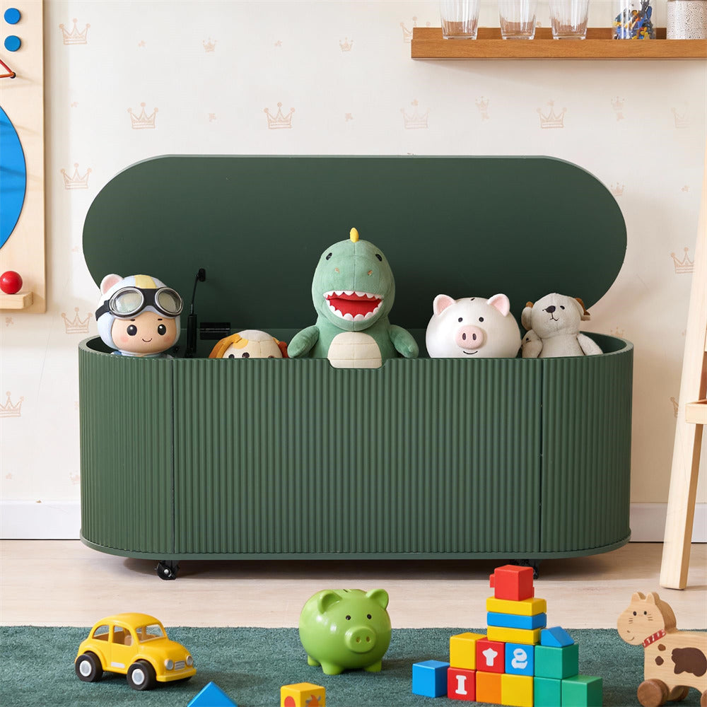 Green toy storage bench with various toys on a wooden floor.