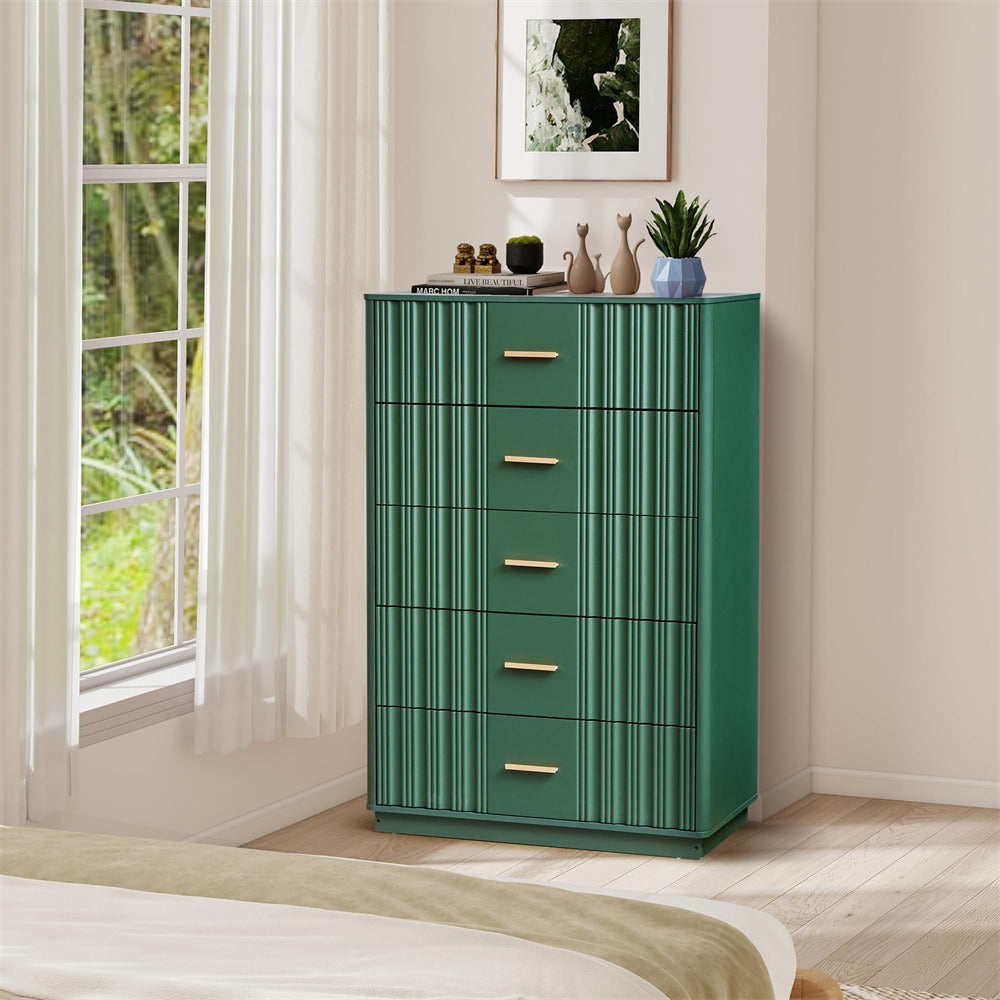 Green 5 drawers dresser with gold handles in a room with a window and plant