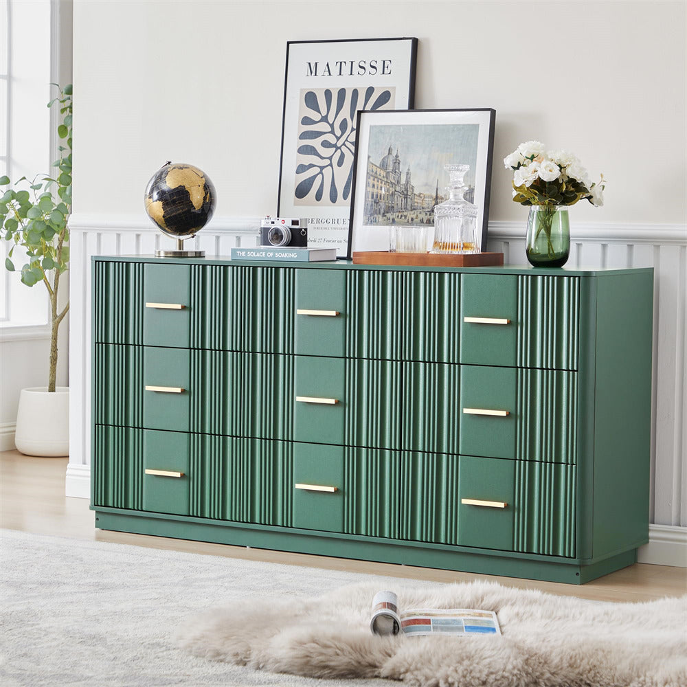 Green 9 drawers dresser with gold accents in a room with decor elements like a plant, vase, and framed pictures.