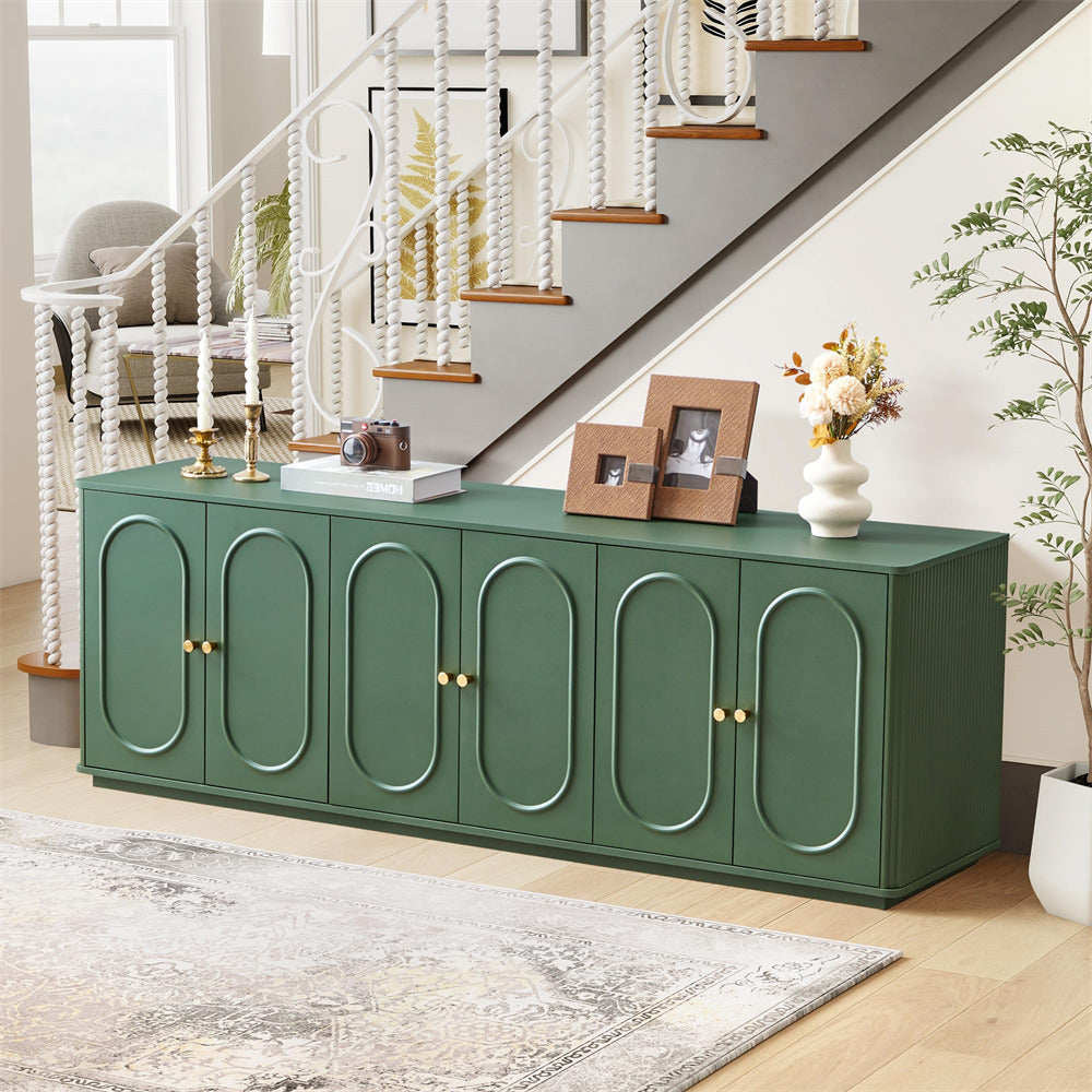 Green sideboard with decorative items in a living room setting