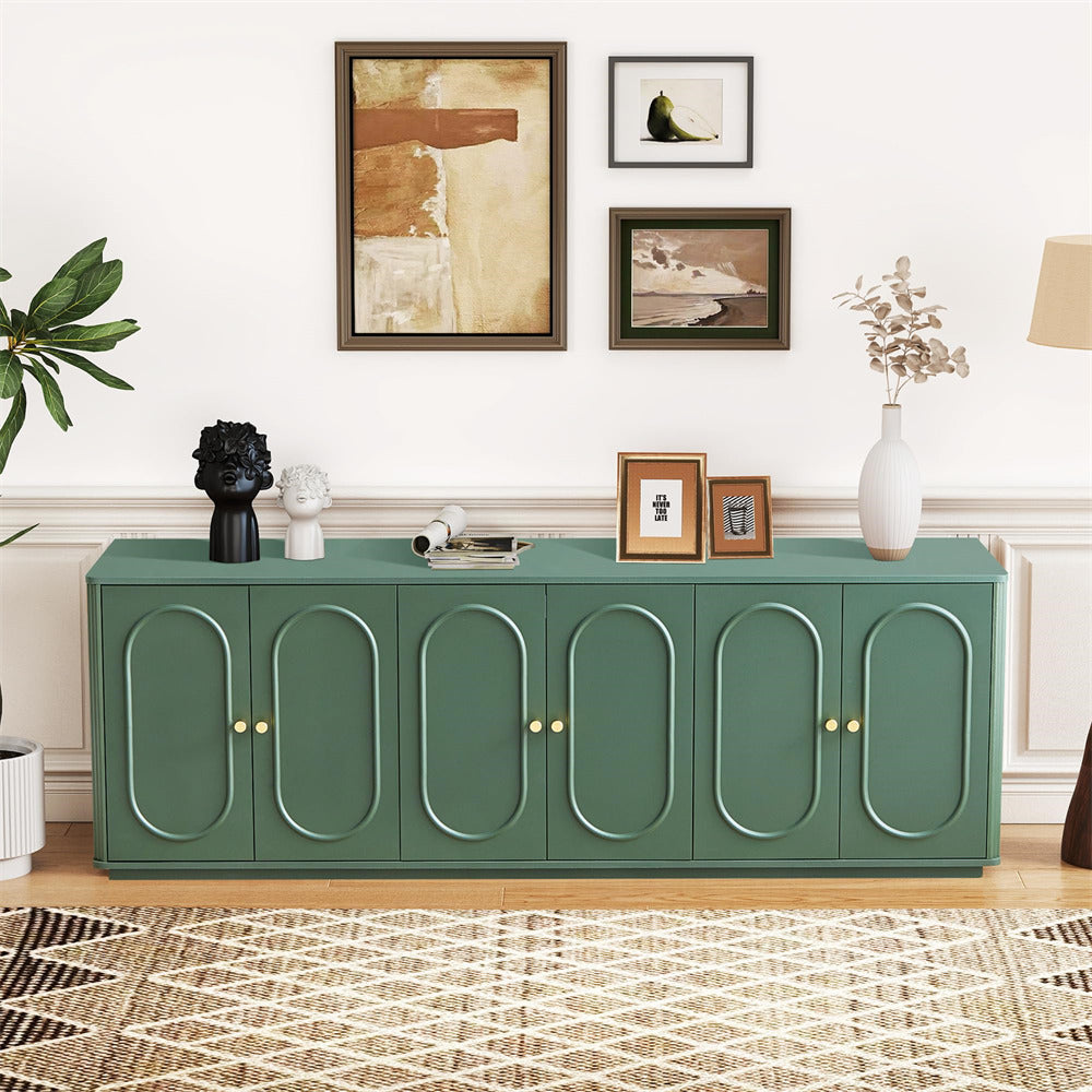 Green sideboard in a living room with decorative items and wall art.