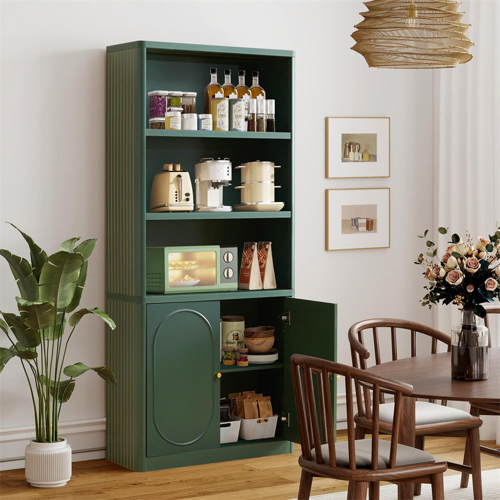 Green bookshelf with kitchen appliances in a room with wooden chairs and a table.