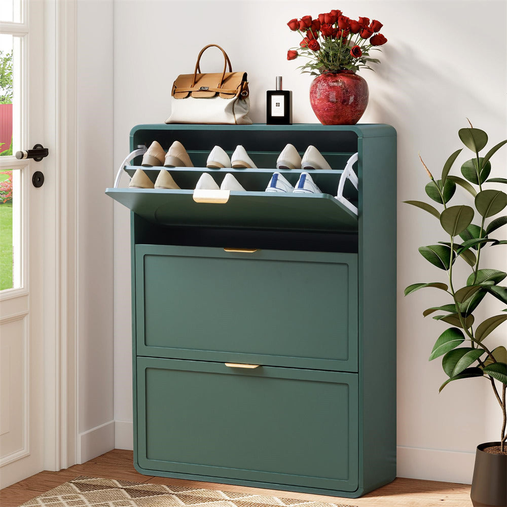 Green shoe cabinet with shoes inside, placed next to a plant in a room.