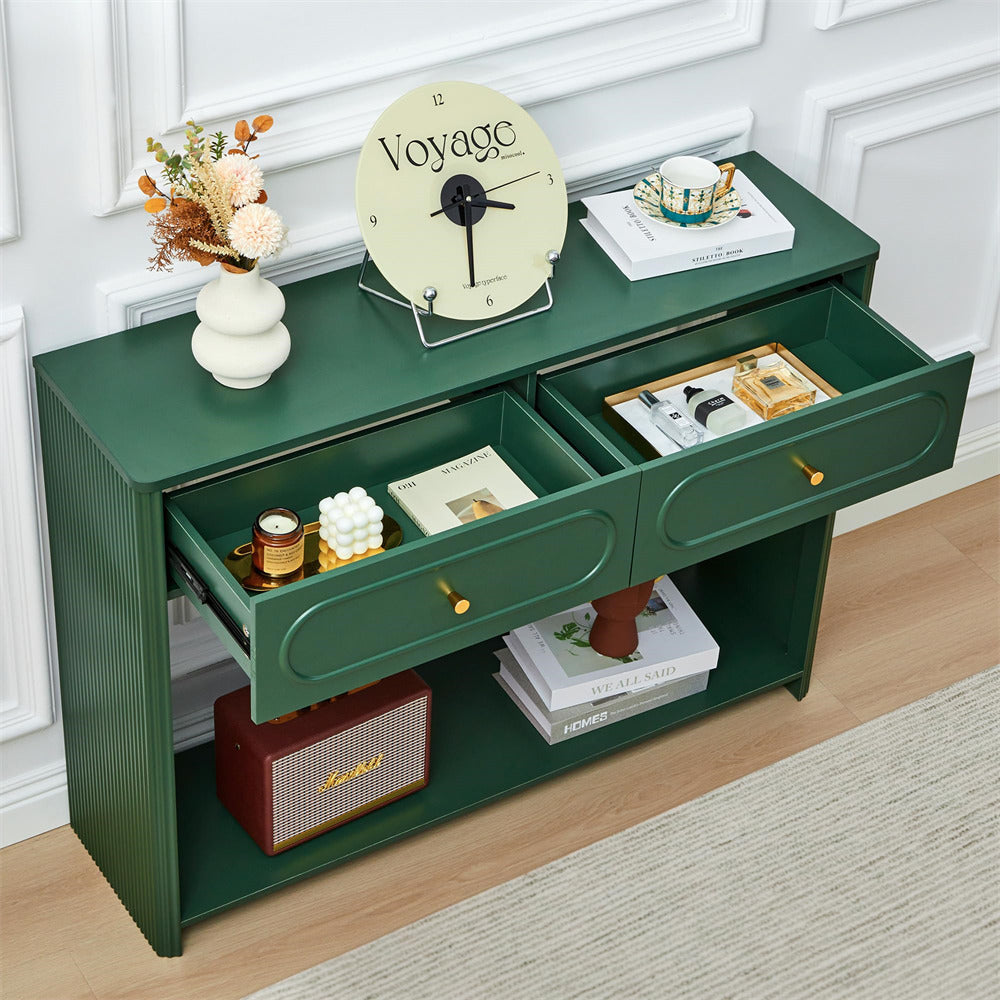 Green console table with two drawers, clock, and decorative items in a room.