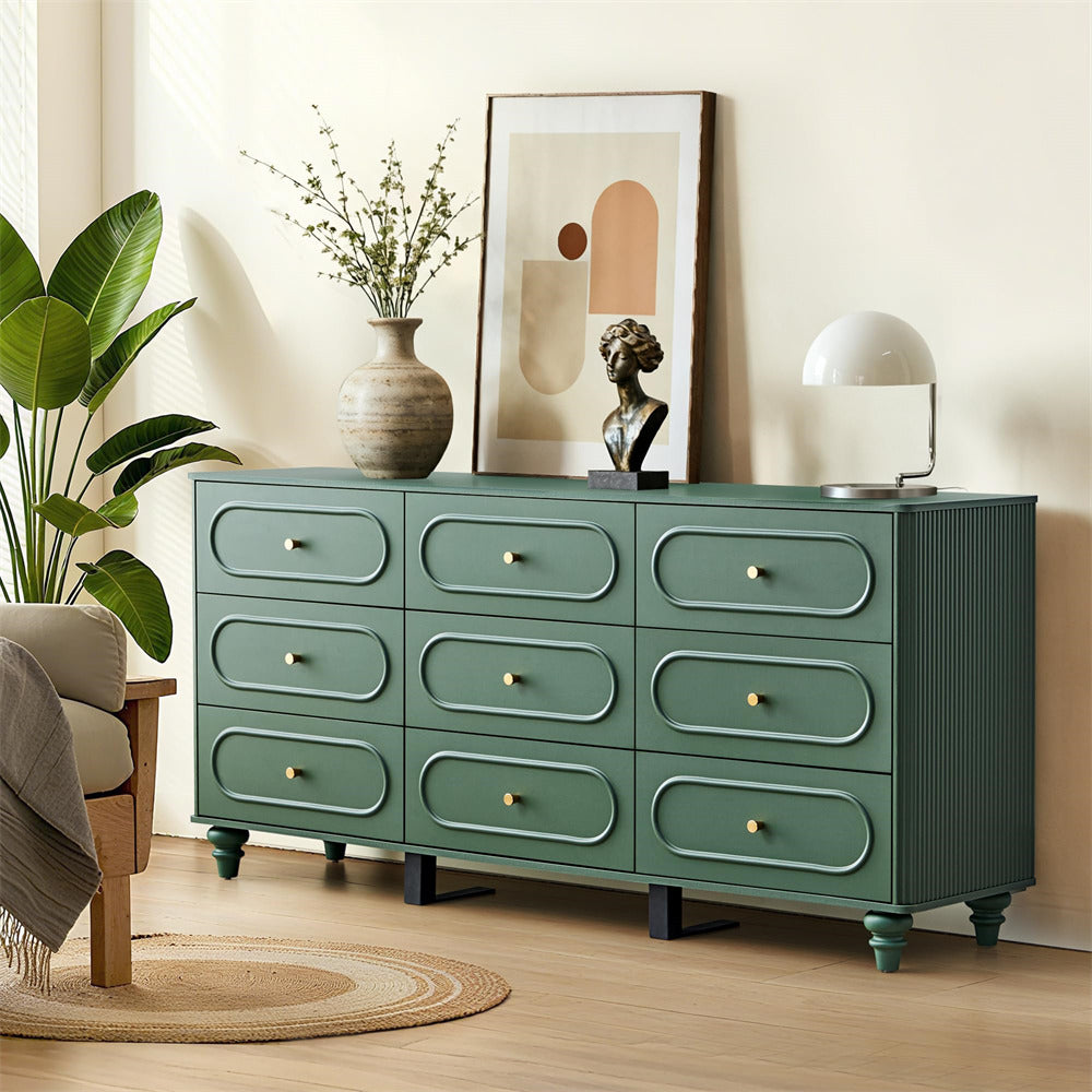Green dresser in a room with decor elements like a plant, vase, and lamp.