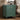 Green nightstand with three drawers in a bedroom setting