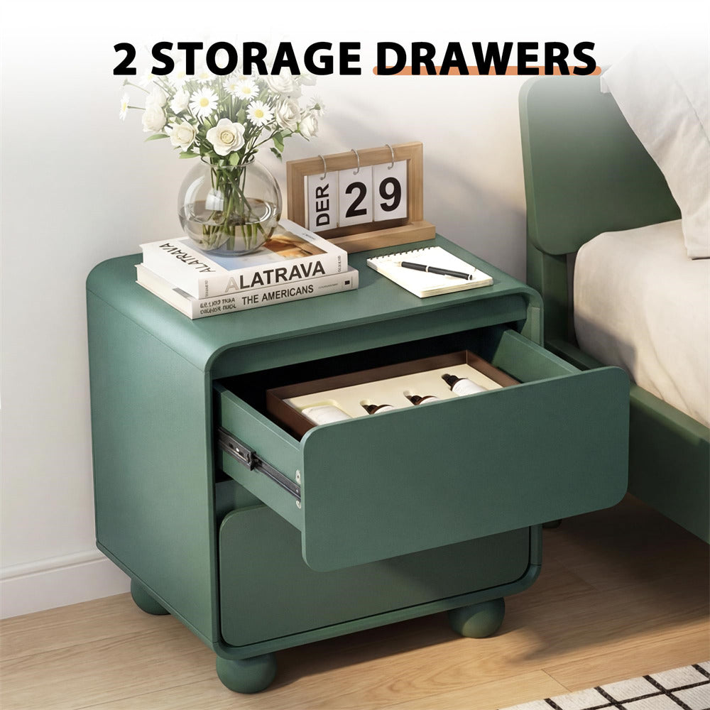 Green nightstand with open drawer, books, and a vase of flowers on a wooden floor.