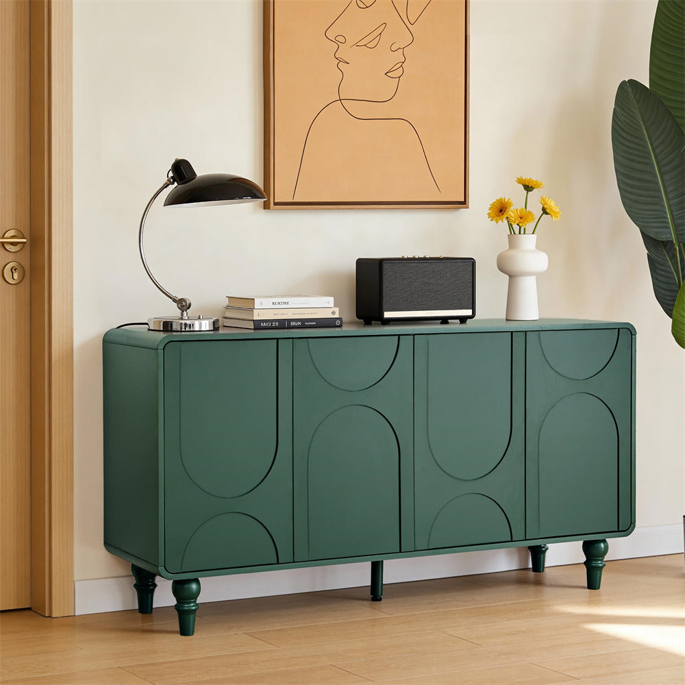 Green sideboard with decorative items in a room with a painting and plant.