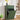 Green trash bin with open lid in a room with decor elements.