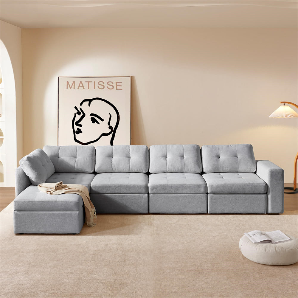 Gray sectional sofa in a living room with a Matisse painting on the wall.