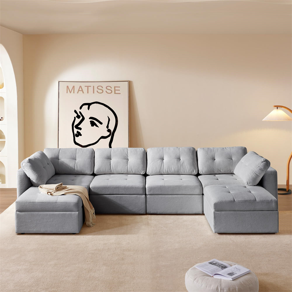 Gray sectional sofa in a living room with a Matisse painting on the wall.