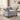 A light gray velvet Chesterfield armchair with button tufting, nailhead trim, and dark turned legs, shown in a styled living room setting.
