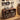 A dark brown wooden media console with rounded corners, styled in a cozy living room setting. The console features open shelves filled with vinyl records, a small clock, and a speaker, and a silver turntable with a clear lid sits on top.