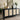 Black cabinet with wicker doors, gold lamp, and decorative items in a room.