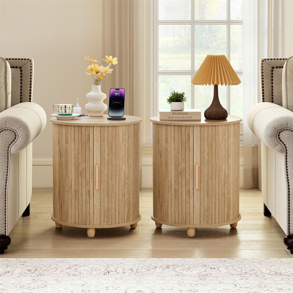 Two round wooden side tables in a living room setting with decor items.