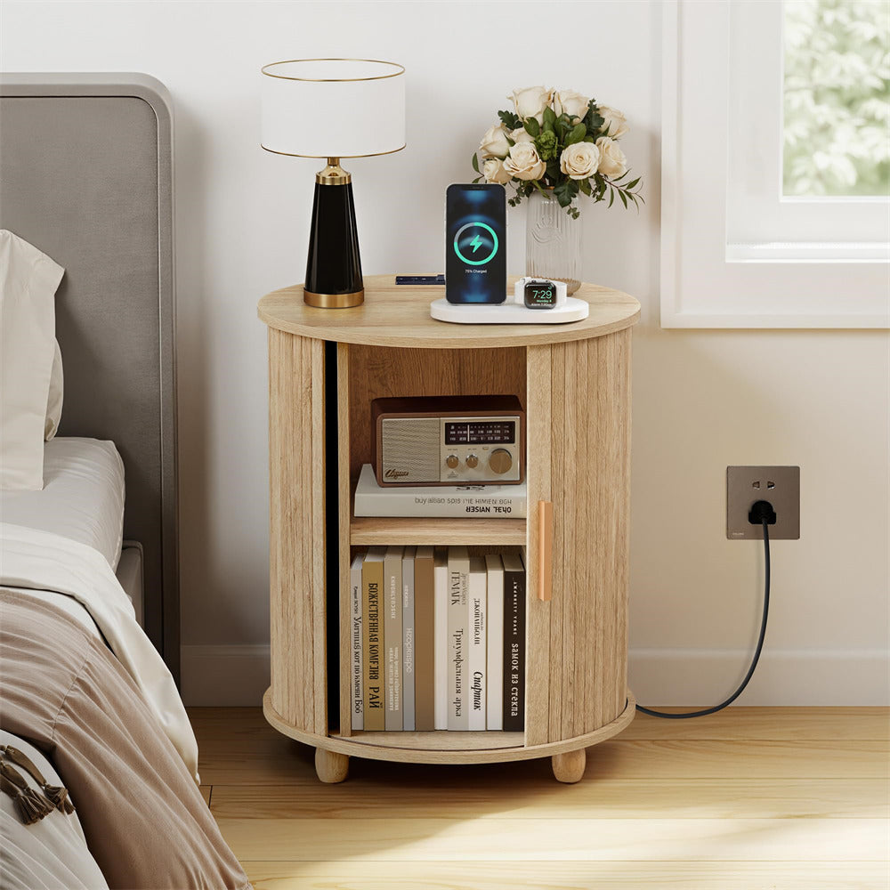 Wooden nightstand with books, lamp, and decorative items in a bedroom setting.
