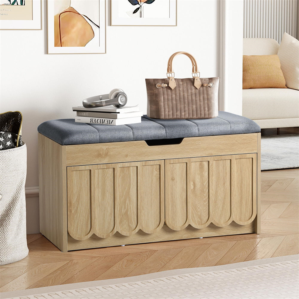 Wooden  shoe storage bench with a gray cushion in a living room setting.