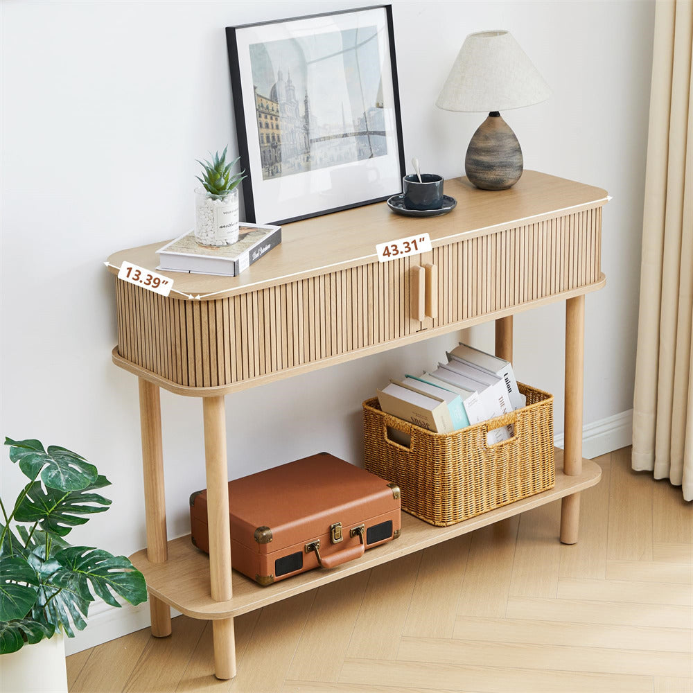 Wooden console table with a lamp, books, and a suitcase in a room setting.