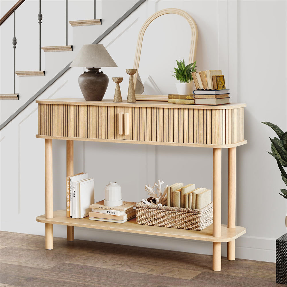 Wooden console table with decorative items against a white wall.