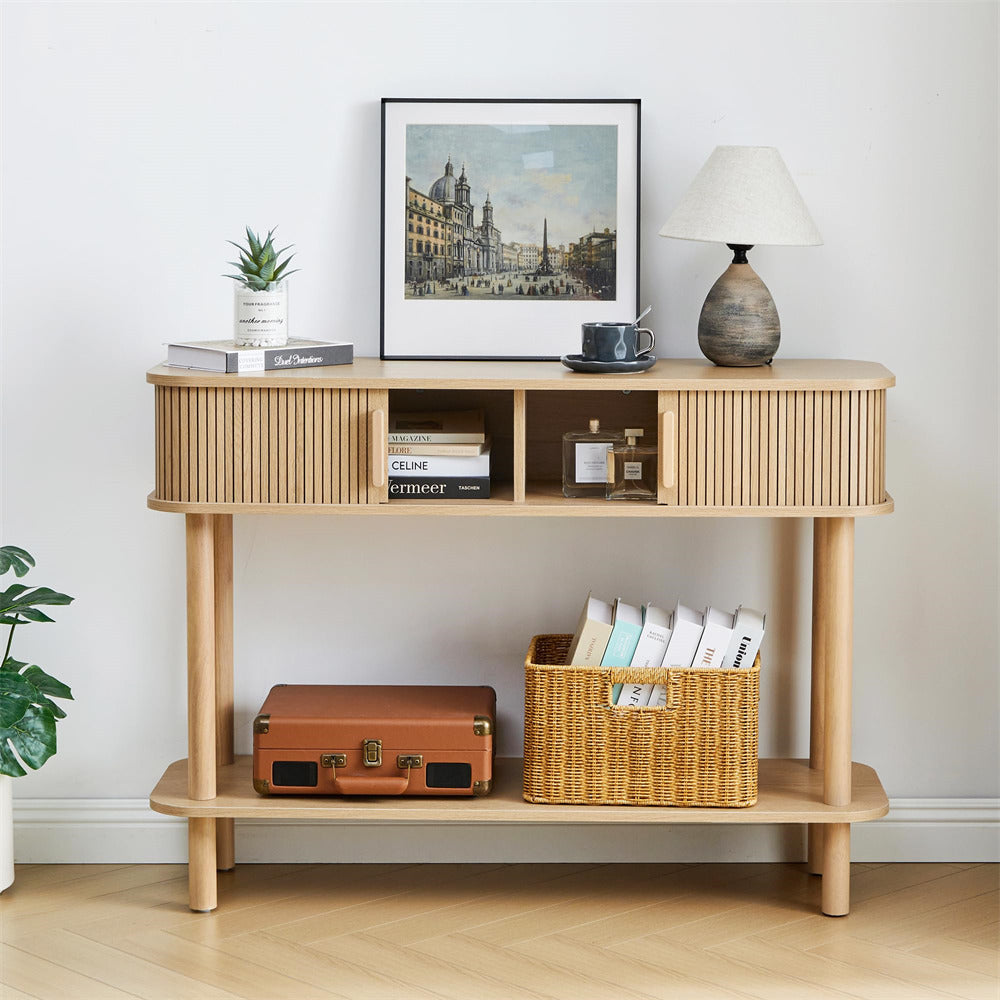 Wooden console table with decorative items against a white wall