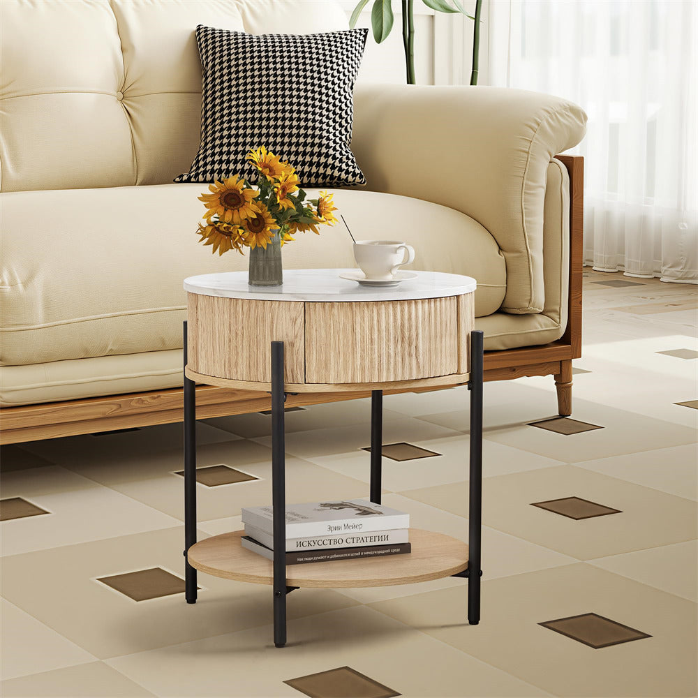 Round coffee table with a vase of sunflowers and books in a living room setting.