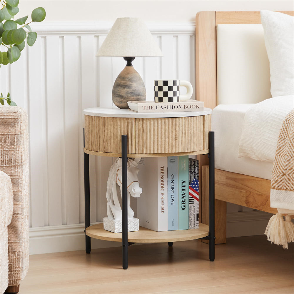Wooden side table with books and decor items next to a bed in a bedroom.