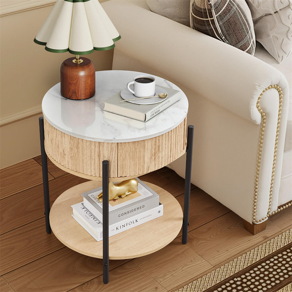 Round side table with marble top and wooden bottom next to a beige sofa.