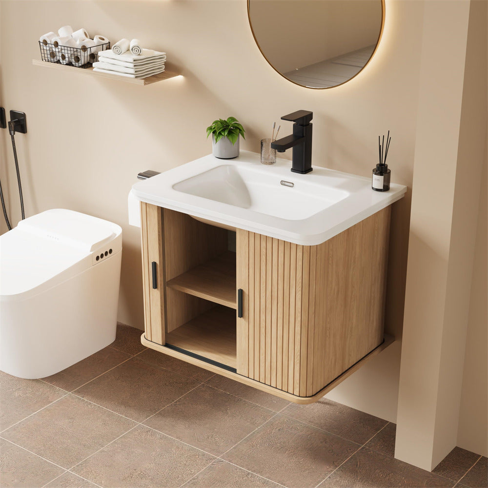 Bathroom with wooden vanity, sink, and toilet.