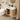 Bathroom with wooden vanity, sink, and toilet.