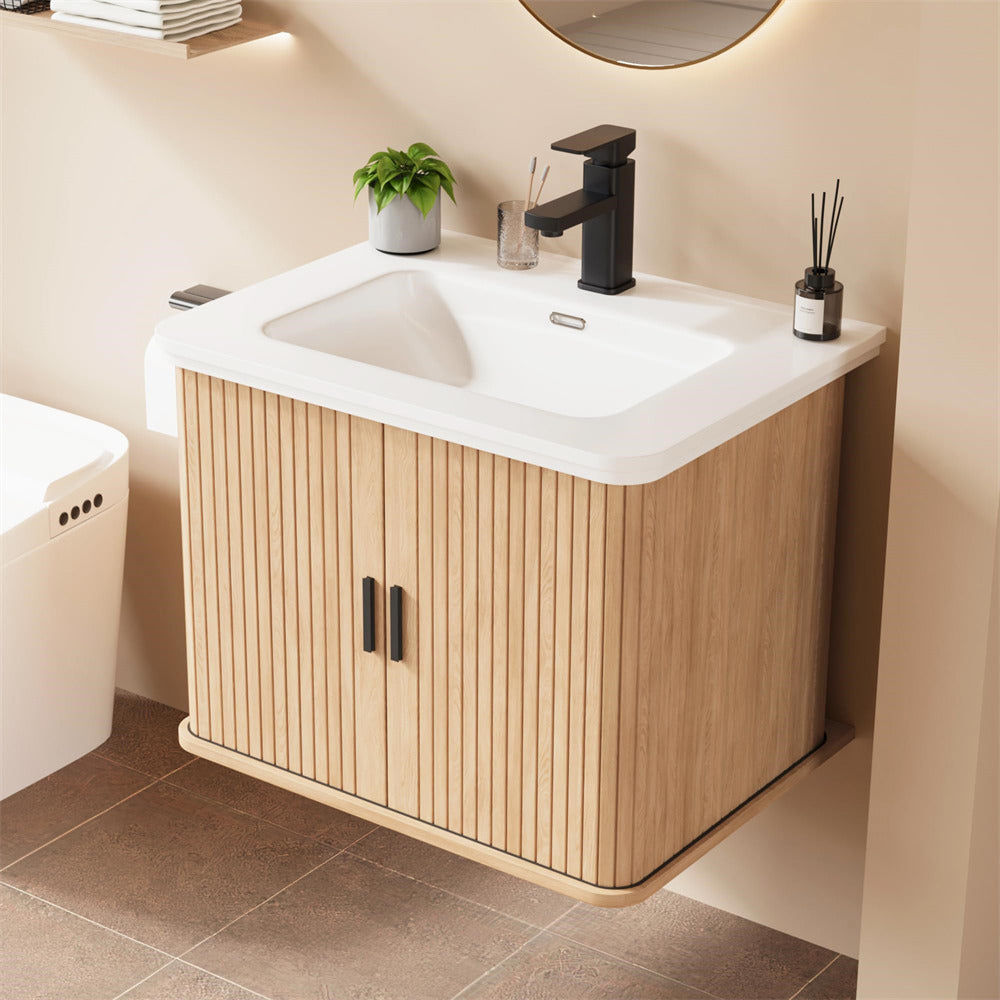 Bathroom vanity with wooden cabinet and white sink, featuring a black faucet.