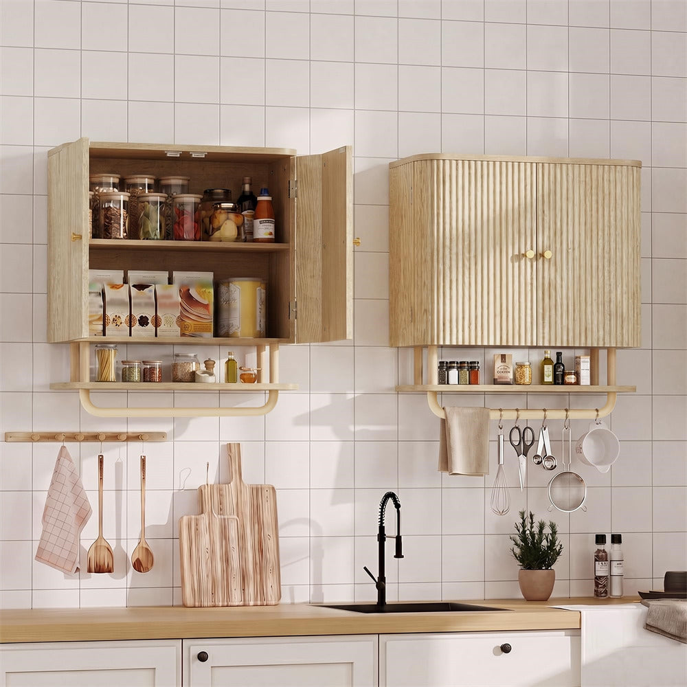 Two light natural wood wall-mounted kitchen cabinets with open lower shelves and hanging utensil hooks, shown installed on a white tiled kitchen wall above a sink with kitchen items.