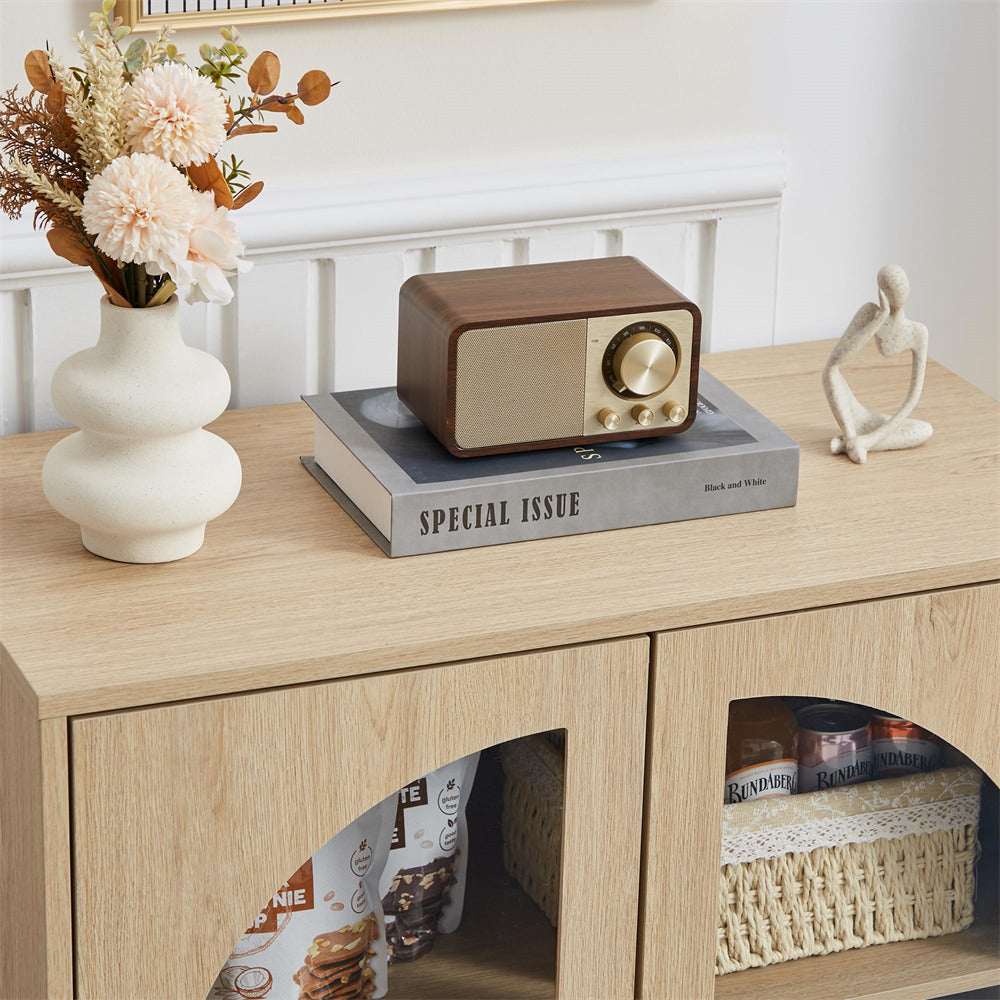 Vintage-style radio on a wooden surface with decorative items