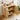 A light natural wood side table with two open doors and two shelves, styled with food and drink items on top and inside. The image includes dimension text overlays showing 15.
