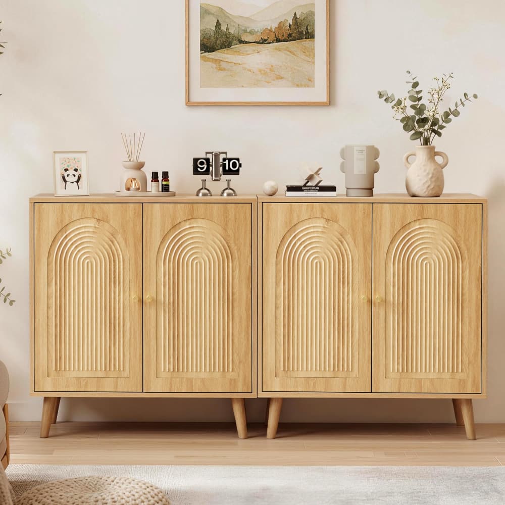 A mid-century modern wooden credenza or sideboard cabinet with four arched door panels, shown in a styled room setting with decorative objects on top.