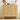 A light natural wood sideboard cabinet with two doors featuring a raised arched rib pattern, styled with food and drink items on top against a white paneled wall.