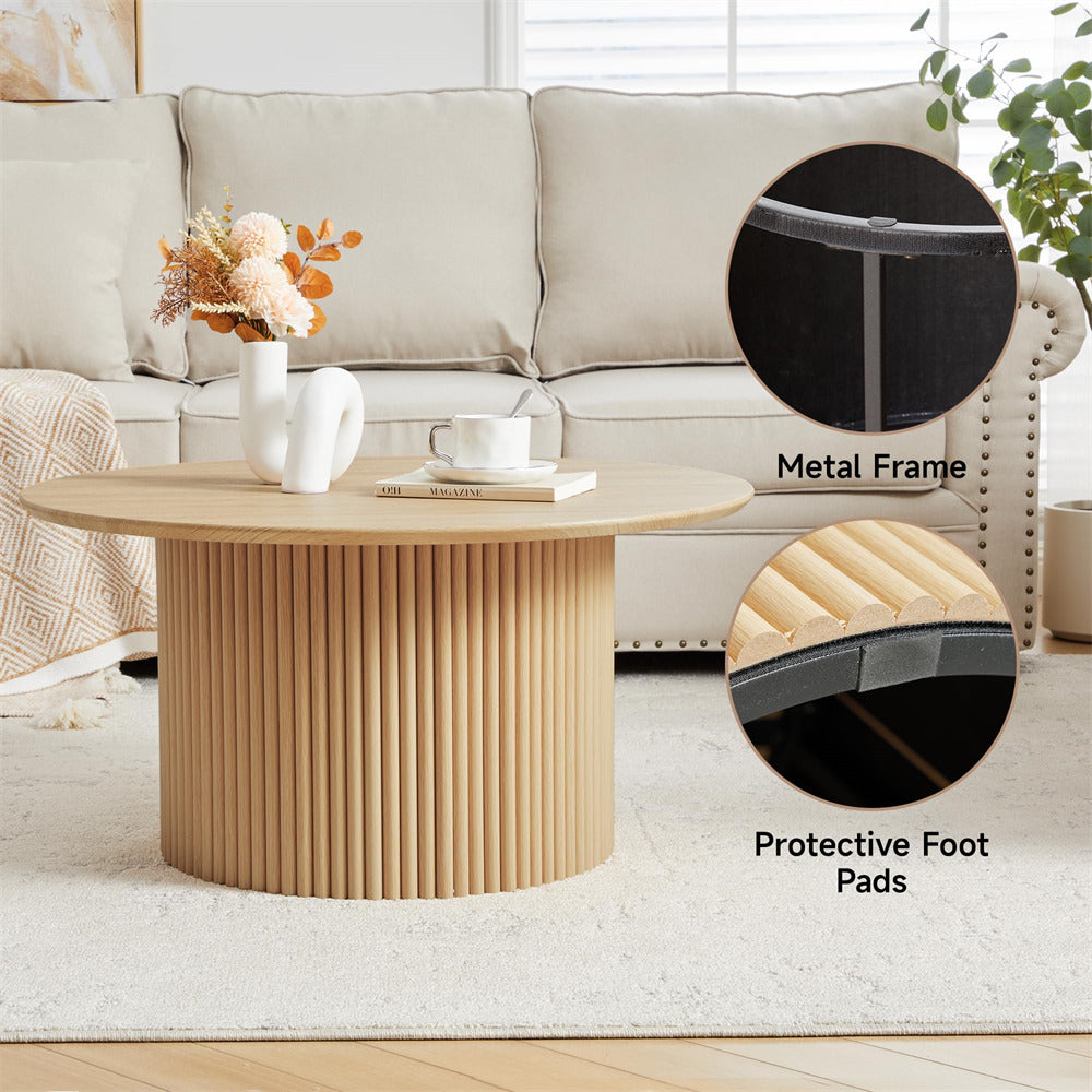 Round wooden coffee table with metal frame and protective foot pads in a living room setting.