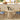 Round wooden dining table with chairs in a kitchen setting