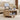 Wooden coffee table with a laptop on an extendable shelf in a living room.